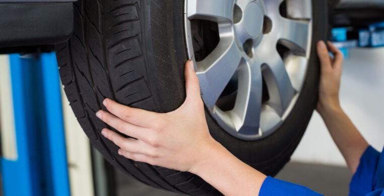 Mechanic adjusting the tire wheel at the repair garage